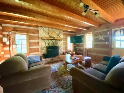 a living room with two couches and a fireplace at Alpine - by The Chalets in Logan