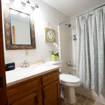 a bathroom with a sink and a toilet and a mirror at Alpine - by The Chalets in Logan