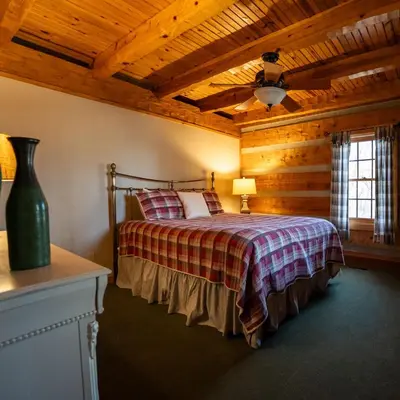 a bedroom with a bed and a wooden ceiling at Aspen - by The Chalets in Logan