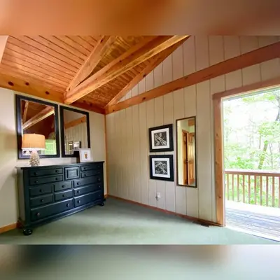 a room with a dresser and a large window at Aspen - by The Chalets in Logan