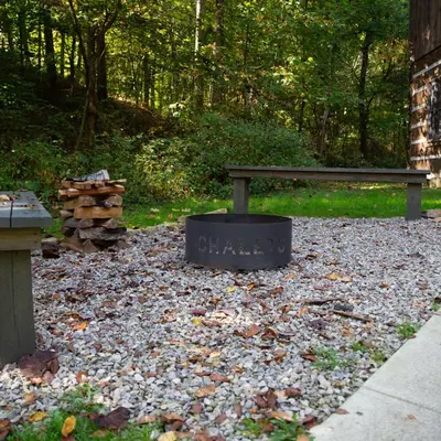 a park bench sitting on a pile of leaves at Aspen - by The Chalets in Logan