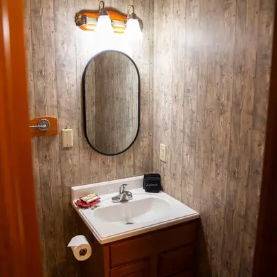 a bathroom with a sink and a mirror at Big Sky Lodge - by The Chalets in Logan