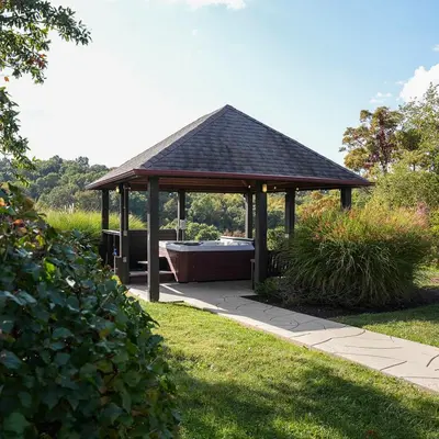 a gazebo with a bath tub in a garden at Big Sky Lodge - by The Chalets in Logan