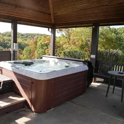 a large hot tub on a patio with a table at Big Sky Lodge - by The Chalets in Logan
