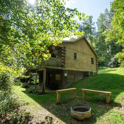 a house with a deck and a fire pit and two benches at Blackjack - by The Chalets in Logan