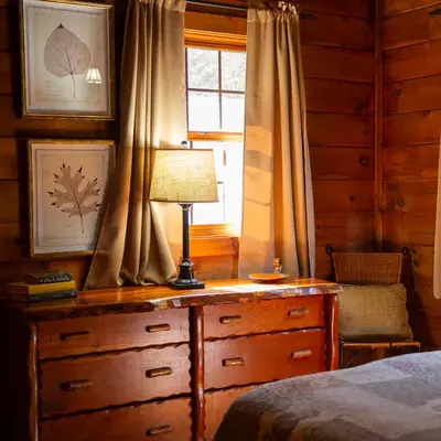 a bedroom with a dresser with a lamp on it at Blackjack - by The Chalets in Logan