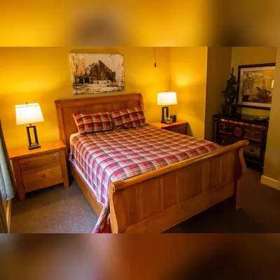a bedroom with a bed with two night stands and two lamps at Couples Paradise I - by The Chalets in Logan