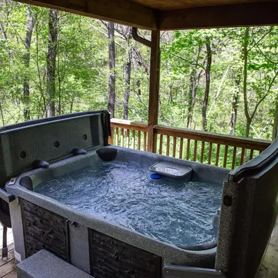 a hot tub on the back of a porch at Couples Paradise I - by The Chalets in Logan