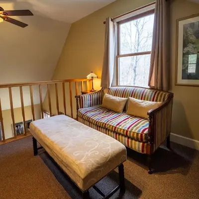 a living room with a couch and a window at Couples Paradise I - by The Chalets in Logan