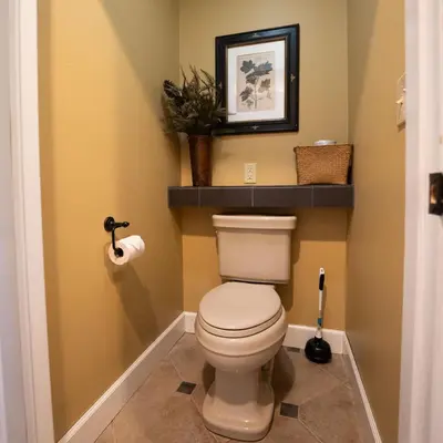 a bathroom with a toilet with a shelf above it at Couples Paradise I - by The Chalets in Logan
