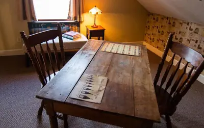 a wooden dining table with two chairs at Couples Paradise I - by The Chalets in Logan