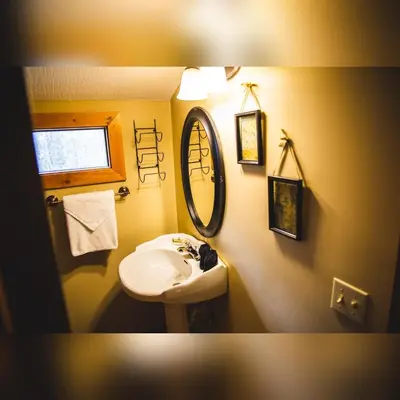 a bathroom with a sink and a mirror at Couples Paradise II - by The Chalets in Logan
