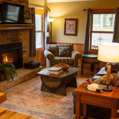 a living room with a couch and a fireplace at Couples Paradise II - by The Chalets in Logan