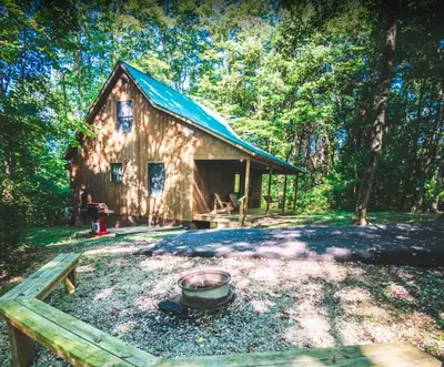 a log cabin with a pot in front of it at Couples Paradise II - by The Chalets in Logan