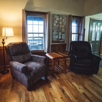 a living room with a chair and a chair and a table at Coyote - by The Chalets in Logan