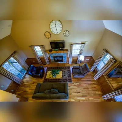 an overhead view of a living room with a clock on the wall at Coyote - by The Chalets in Logan