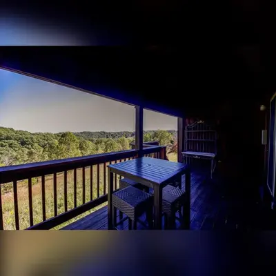 a table and two chairs on a balcony with a view at Coyote - by The Chalets in Logan