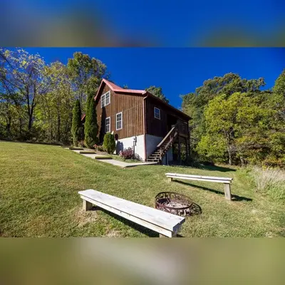 a house with two benches in front of it at Coyote - by The Chalets in Logan