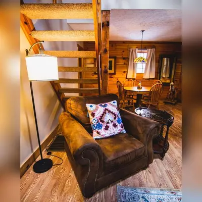 a living room with a couch and a table at Cumberland - by The Chalets in Logan