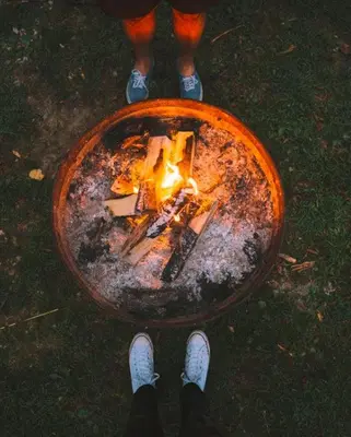 a person standing with a fire in a bowl at Cumberland - by The Chalets in Logan