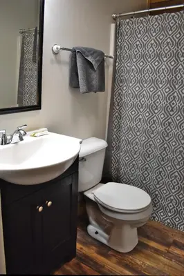 a bathroom with a toilet and a sink and a shower at Cumberland - by The Chalets in Logan
