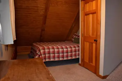 a small room with a bed and a table at Cumberland - by The Chalets in Logan