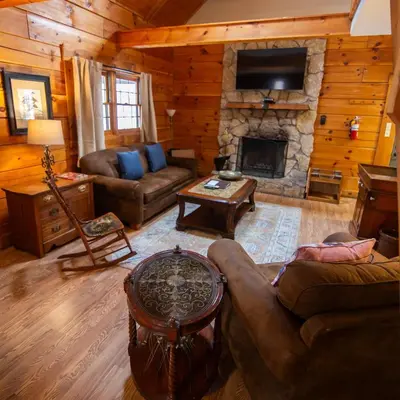 a living room with a couch and a fireplace at Cumberland - by The Chalets in Logan