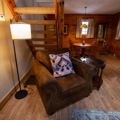 a living room with a couch and a table at Cumberland - by The Chalets in Logan