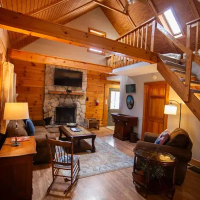 a living room with a couch and a fireplace at Cumberland - by The Chalets in Logan