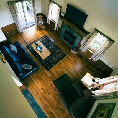 an overhead view of a living room with a couch and a television at Deer Run - by The Chalets in Logan