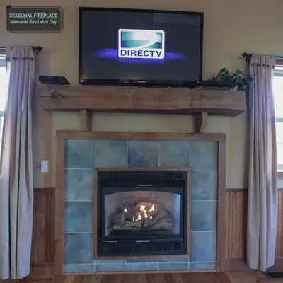 a fireplace with a television on top of it at Deer Run - by The Chalets in Logan