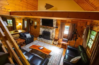 an overhead view of a living room with a fireplace at Dogwood - by The Chalets in Logan