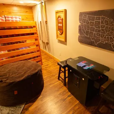 a room with a bed and a table in a room at Dogwood - by The Chalets in Logan