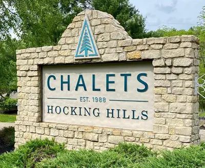 a sign for chateslocking hills in a stone wall at Elk - by The Chalets in South Bloomingville