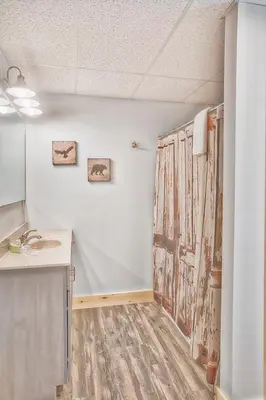 a room with a kitchen with a sink and a counter at Evergreen - by The Chalets in Laurelville