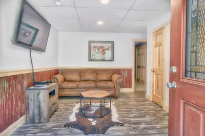 a living room with a couch and a table at Evergreen - by The Chalets in Laurelville