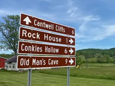 a street sign with several signs in a field at Evergreen - by The Chalets in Laurelville
