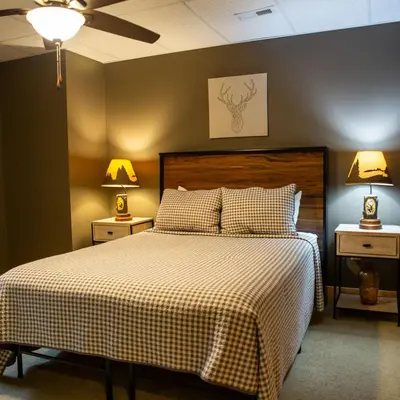 a bedroom with a bed with two night stands and two lamps at Evergreen - by The Chalets in Laurelville