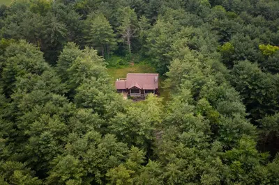 an aerial view of a house in the middle of trees at Evergreen - by The Chalets in Laurelville