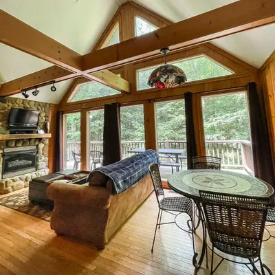 a living room with a couch and a table at Falls - by The Chalets in Logan