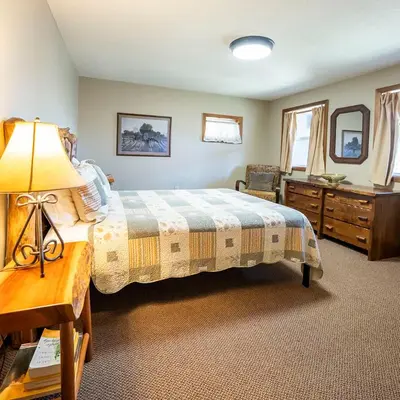 a bedroom with a bed and a dresser and a desk at Fallswood Lodge - by The Chalets in Logan