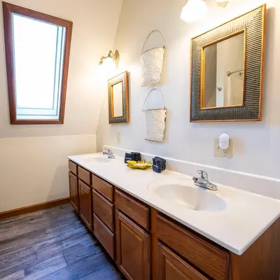a bathroom with a sink and a mirror at Fallswood Lodge - by The Chalets in Logan