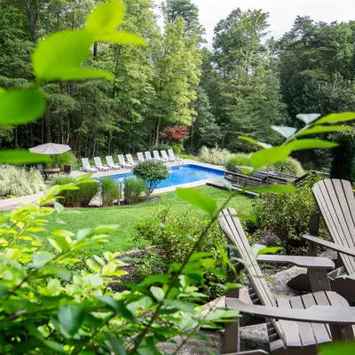 a yard with chairs and a swimming pool at Fallswood Lodge - by The Chalets in Logan