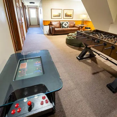 a living room with a table and a couch at Fallswood Lodge - by The Chalets in Logan