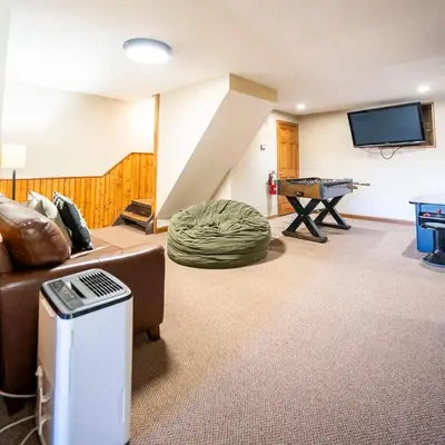 a living room with a couch and a table at Fallswood Lodge - by The Chalets in Logan