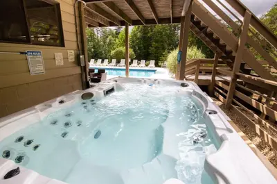 a jacuzzi tub in the backyard of a house at Fireside Lodge - by The Chalets in Logan