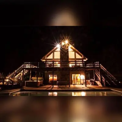 a building with a light on top at night at Fireside Lodge - by The Chalets in Logan