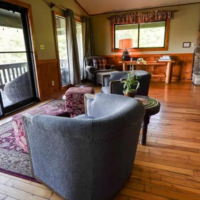 a living room with couches and chairs and a table at Grande Butte Lodge - by The Chalets in Laurelville