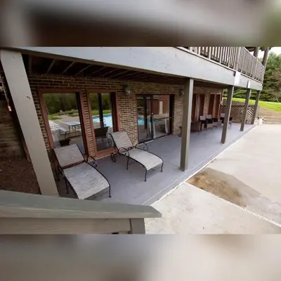 a patio with chairs and a table and a building at Grande Butte Lodge - by The Chalets in Laurelville