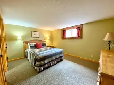 a bedroom with a bed and a window at Grande Butte Lodge - by The Chalets in Laurelville
